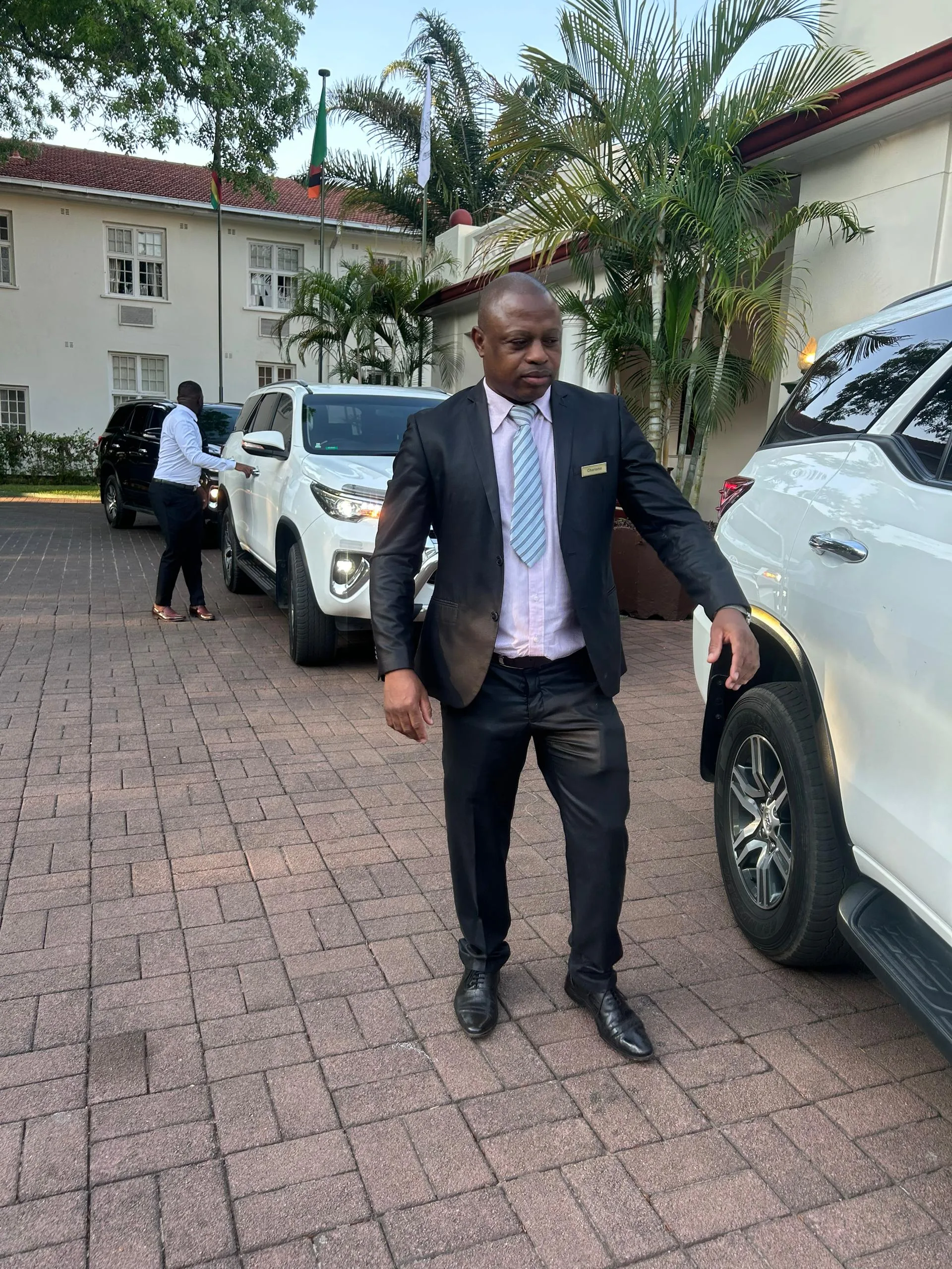 Driver opening the door for a VIP transfer